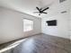 Bright bedroom featuring wood-look floors and ceiling fan at 1698 Hubbell Rd, Wesley Chapel, FL 33543