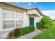 Inviting exterior with green landscaping and a green door at 1931 Sassafras Dr, Wesley Chapel, FL 33543
