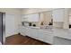 White kitchen cabinets, granite countertops, and stainless steel appliances at 1931 Sassafras Dr, Wesley Chapel, FL 33543