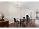 Dining room features hardwood floors and a chandelier at 1931 Sassafras Dr, Wesley Chapel, FL 33543