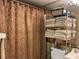 Bathroom with patterned shower curtain and shelving at 20857 Haulover Cv # B-13, Lutz, FL 33558