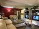 Bright living room with mirrored wall and comfy beige sofas at 20857 Haulover Cv # B-13, Lutz, FL 33558
