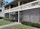 Light green condo building with screened patios and landscaped grounds at 20857 Haulover Cv # B-13, Lutz, FL 33558