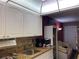Kitchen boasts granite counters, white cabinets, and appliances at 20857 Haulover Cv # B-13, Lutz, FL 33558