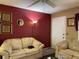 Living room with beige sofas and red walls at 20857 Haulover Cv # B-13, Lutz, FL 33558