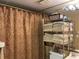 Bathroom with shower and plenty of shelving at 20857 Haulover Cv # B-13, Lutz, FL 33558
