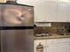 Stainless steel refrigerator and white cabinets at 20857 Haulover Cv # B-13, Lutz, FL 33558