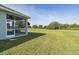 Large backyard with an enclosed patio on the side of the home at 2293 Dog Leg Ct, Brooksville, FL 34604