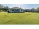 Spacious backyard featuring a covered patio with plenty of green space at 2293 Dog Leg Ct, Brooksville, FL 34604