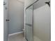 Bathroom showing the walk-in shower with white tile and glass door at 2293 Dog Leg Ct, Brooksville, FL 34604