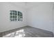 Bright bedroom with a large window and modern gray wood-look flooring at 2293 Dog Leg Ct, Brooksville, FL 34604