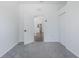 Spacious bedroom with carpet flooring, with a view to the hall and kitchen at 2293 Dog Leg Ct, Brooksville, FL 34604