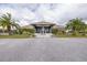 Community clubhouse featuring a welcoming entrance, well-maintained landscaping, and plenty of parking at 2293 Dog Leg Ct, Brooksville, FL 34604