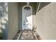 Close-up of a front door with decorative tile, elegant lighting, and neutral stucco facade at 2293 Dog Leg Ct, Brooksville, FL 34604