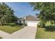 Charming home on a well-manicured lawn with a large driveway and two-car garage at 2293 Dog Leg Ct, Brooksville, FL 34604
