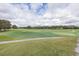 Scenic view of the golf course, featuring lush fairways, blue skies, and meticulously maintained greens at 2293 Dog Leg Ct, Brooksville, FL 34604
