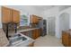 Modern kitchen features wood cabinets, granite countertops, stainless steel appliances, and decorative backsplash at 2293 Dog Leg Ct, Brooksville, FL 34604