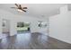Spacious living room with a ceiling fan and sliding glass doors to the outside at 2293 Dog Leg Ct, Brooksville, FL 34604