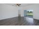 Open living room with ceiling fan and sliding glass doors to the backyard at 2293 Dog Leg Ct, Brooksville, FL 34604