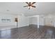 A spacious living room showcasing wood-look flooring, and arched doorway at 2293 Dog Leg Ct, Brooksville, FL 34604