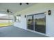 Covered patio with sliding glass doors overlooking a large backyard at 2293 Dog Leg Ct, Brooksville, FL 34604