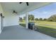 View of the screened lanai overlooking the backyard and beyond at 2293 Dog Leg Ct, Brooksville, FL 34604