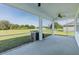 View of the screened lanai overlooking the green lawn at 2293 Dog Leg Ct, Brooksville, FL 34604