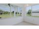 Bright sunroom with large windows offering scenic views of the surrounding landscape and golf course at 2293 Dog Leg Ct, Brooksville, FL 34604