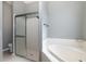 Clean bathroom featuring a shower, tub, and updated fixtures at 2293 Dog Leg Ct, Brooksville, FL 34604