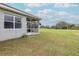 Home exterior showcasing a screened porch and expansive lawn at 2293 Dog Leg Ct, Brooksville, FL 34604