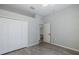 Well-lit bedroom with double door closet and wood-look flooring at 2293 Dog Leg Ct, Brooksville, FL 34604