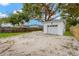 Detached one car garage with gravel driveway and partial fenced yard at 4136 9Th N Ave, St Petersburg, FL 33713