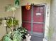 Inviting front entrance with a burgundy door and seasonal decor at 427 Windrush Bay Dr # 427, Tarpon Springs, FL 34689