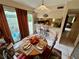 Bright dining area with a round table, access to a patio, and kitchen views at 427 Windrush Bay Dr # 427, Tarpon Springs, FL 34689