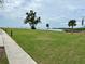 Scenic waterfront view with grassy area and benches at 427 Windrush Bay Dr # 427, Tarpon Springs, FL 34689