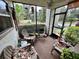 Peaceful screened porch with comfy seating and potted plants at 427 Windrush Bay Dr # 427, Tarpon Springs, FL 34689