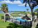 Inviting community pool with waterfront views and shaded seating at 427 Windrush Bay Dr # 427, Tarpon Springs, FL 34689