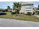 Building exterior with landscaping and a palm tree at 427 Windrush Bay Dr # 427, Tarpon Springs, FL 34689