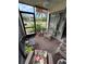 Peaceful screened porch with chairs and potted plants at 427 Windrush Bay Dr # 427, Tarpon Springs, FL 34689