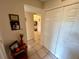 Bright hallway with built-in storage and view of bathroom at 427 Windrush Bay Dr # 427, Tarpon Springs, FL 34689