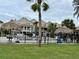 Community pool with palm trees and lounge chairs at 427 Windrush Bay Dr # 427, Tarpon Springs, FL 34689