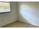 Small, sunny bedroom features tile floors and a window with blinds at 4913 Hazner St # 4913, New Port Richey, FL 34652