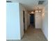 Hallway features tile floors and a classic chandelier, providing ample lighting to the space at 4913 Hazner St # 4913, New Port Richey, FL 34652