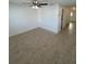 Bright, minimalist living room featuring neutral tile flooring and a ceiling fan at 4913 Hazner St # 4913, New Port Richey, FL 34652