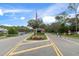 Gated entrance to a community with landscaping and flag at 6423 Lost Tree Ln, Spring Hill, FL 34606