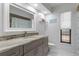 This bathroom has a granite countertop and a large mirror at 6450 Trade Ct, Spring Hill, FL 34606