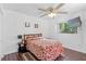 Comfortable bedroom features hard surface floors, a window for natural light, and a ceiling fan at 6450 Trade Ct, Spring Hill, FL 34606