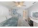 Bright bedroom with a modern vanity, ceiling fan, and a serene butterfly wall decor at 6450 Trade Ct, Spring Hill, FL 34606