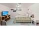 Simple bedroom with a TV, wood-look shelving and an air conditioning unit at 6450 Trade Ct, Spring Hill, FL 34606