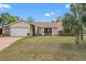Well-maintained home with lush lawn and landscaping, including a two car garage at 6450 Trade Ct, Spring Hill, FL 34606
